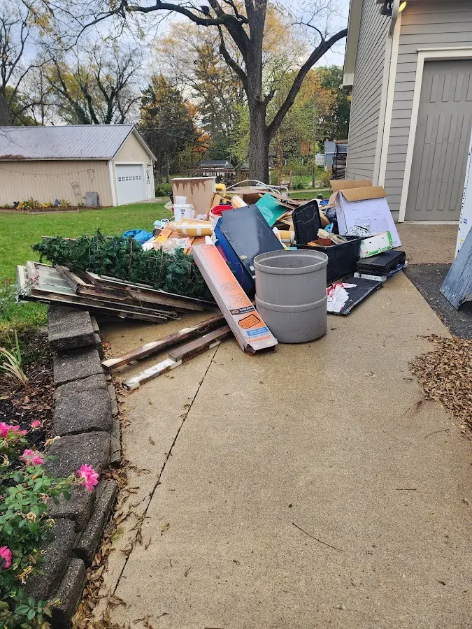 Dumpster being loaded with debris for 12 Yard Dumpster Rental in Lake Forest Park
